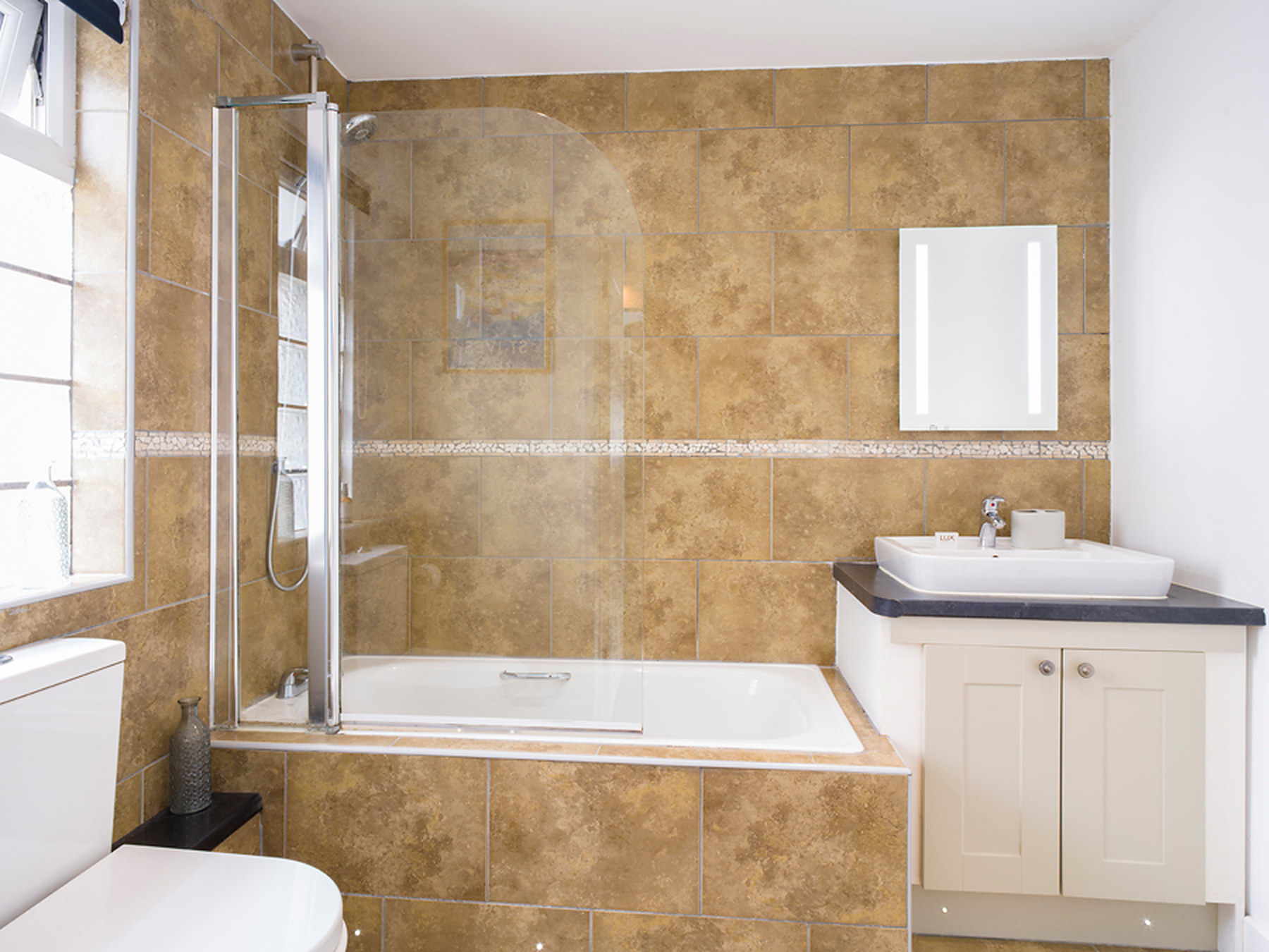 Bathroom with a bath, shower over, basin and WC