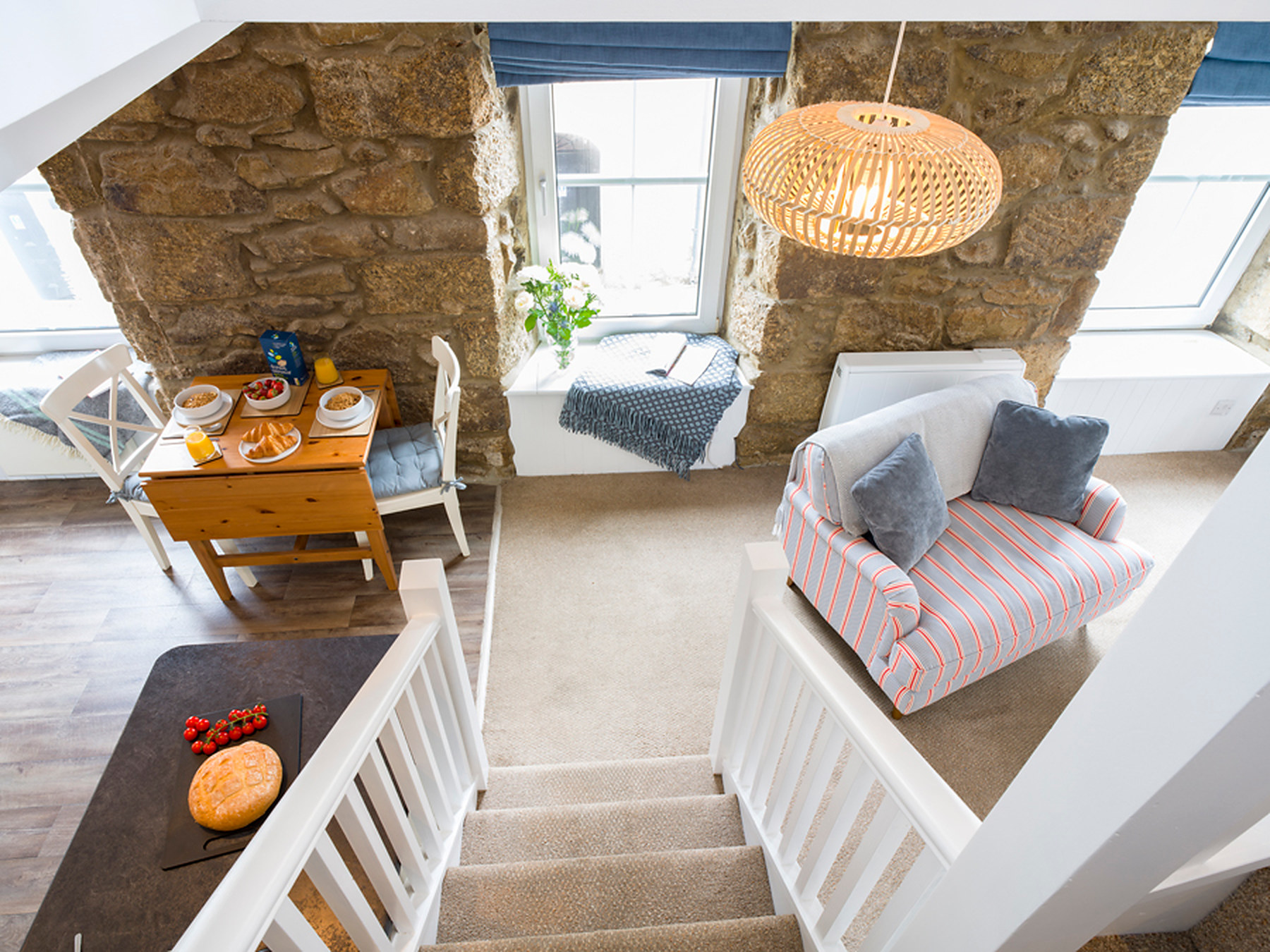 View down the stairs to the dining table and sitting area below